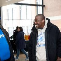 Two gentleman chatting with each other and smiling
